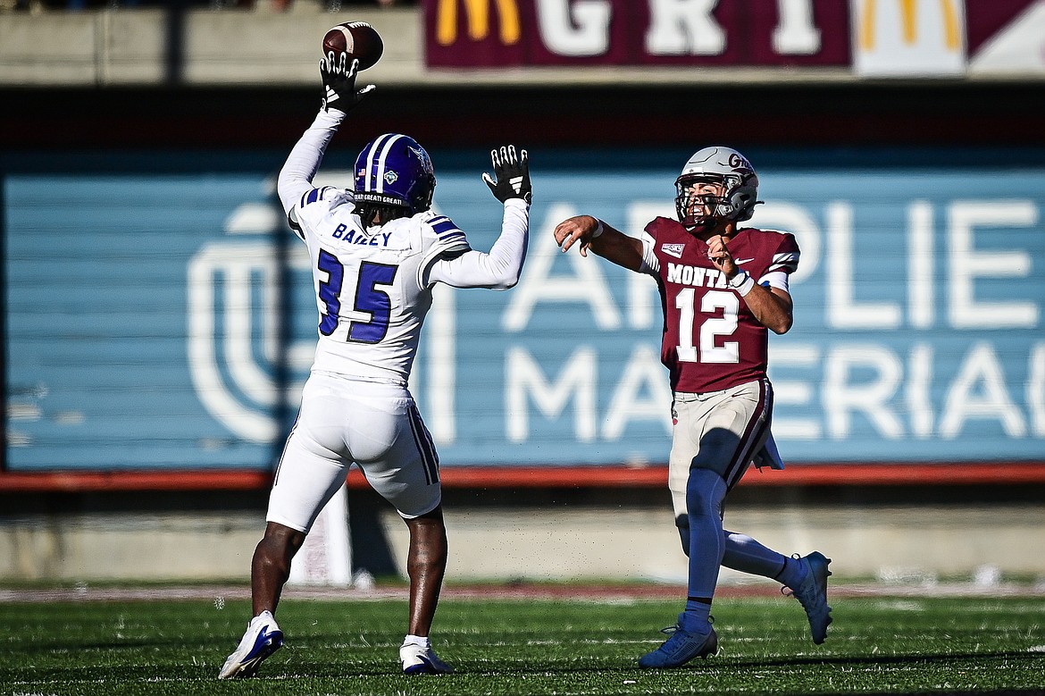 Grizzlies quarterback Logan Fife (12) completes a pass to wide receiver Keelan White in the fourth quarter against Weber State at Washington-Grizzly Stadium on Saturday, Oct. 5. (Casey Kreider/Daily Inter Lake)