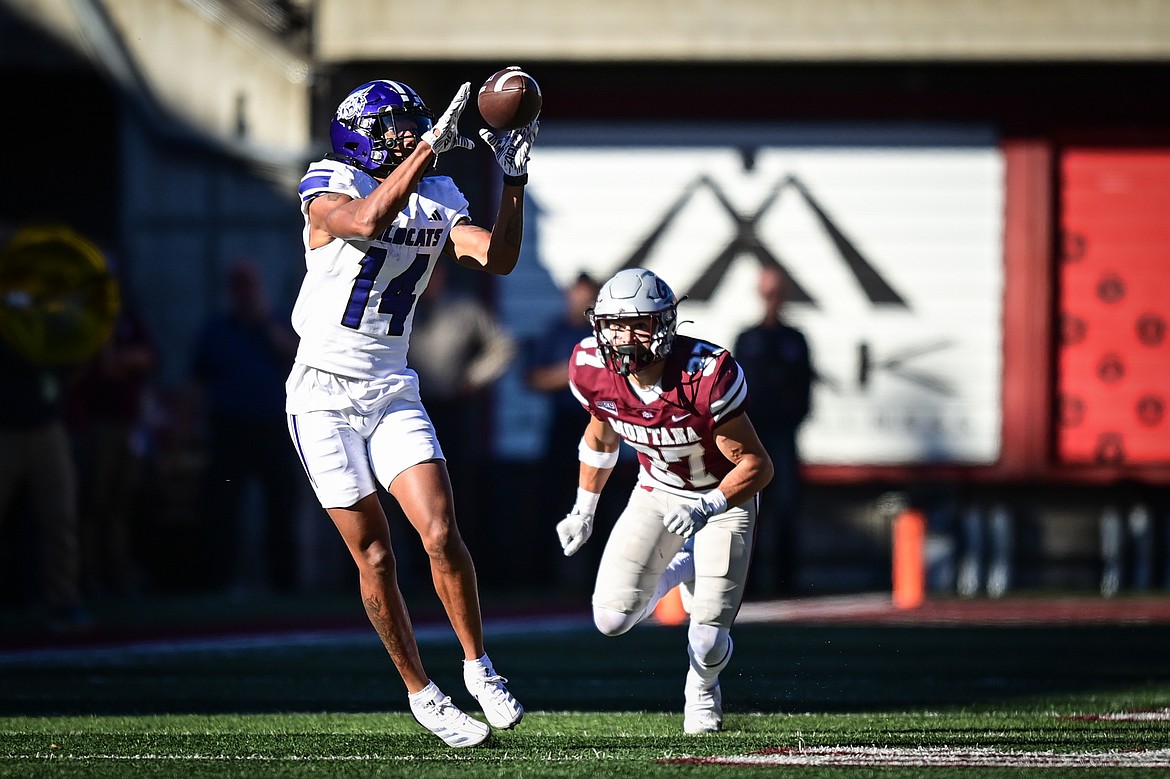 Weber State wide receiver Jacob Sharp (14) catches a pass defended by Grizzlies cornerback Trevin Gradney (37) in the fourth quarter at Washington-Grizzly Stadium on Saturday, Oct. 5. (Casey Kreider/Daily Inter Lake)