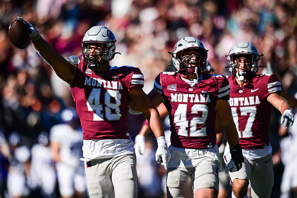 Grizzlies defenders Hayden Harris (48), Riley Wilson (42) and Kade Boyd (17) celebrate after Harris sacked Weber State quarterback Richie Munoz causing a fumble which Harris recovered in the second quarter at Washington-Grizzly Stadium on Saturday, Oct. 5. (Casey Kreider/Daily Inter Lake)