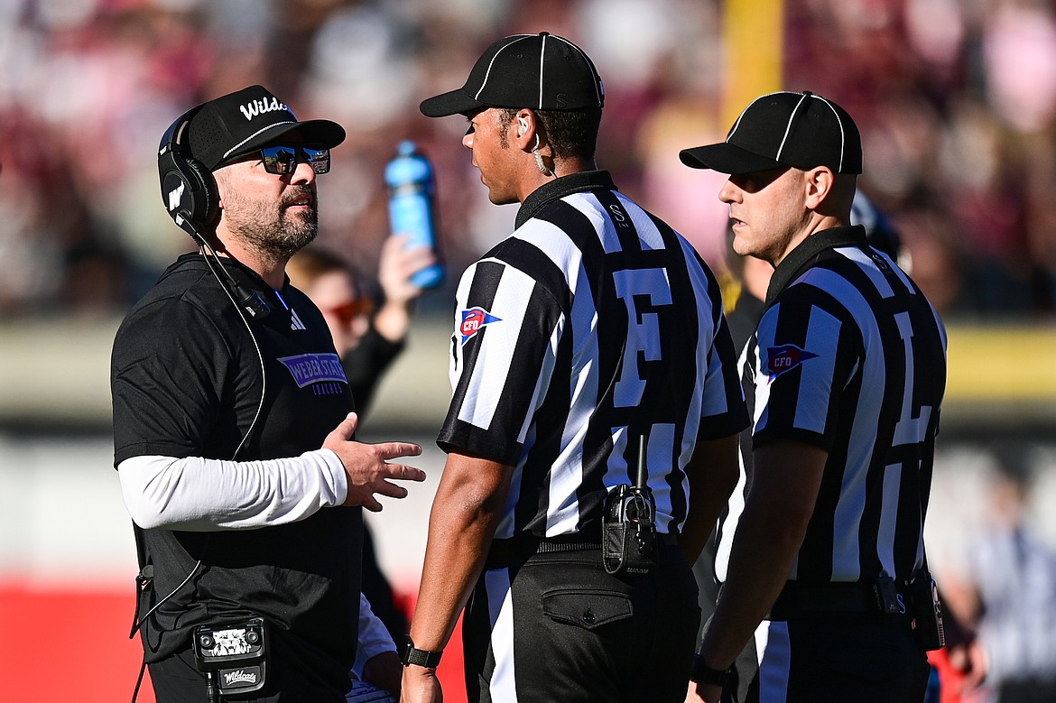 Weber State head coach Mickey Mental talks to the referees during a challenged play in overtime against Montana at Washington-Grizzly Stadium on Saturday, Oct. 5. (Casey Kreider/Daily Inter Lake)