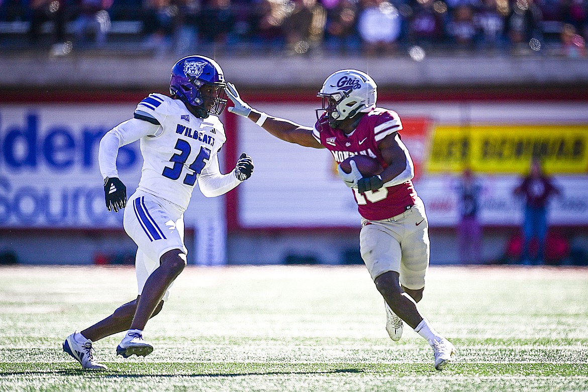 Grizzlies running back Eli Gillman (10) stiff-arms Weber State defender Kemari Munier-Bailey (35) on a 68-yard touchdown reception in the third quarter against Weber State at Washington-Grizzly Stadium on Saturday, Oct. 5. (Casey Kreider/Daily Inter Lake)