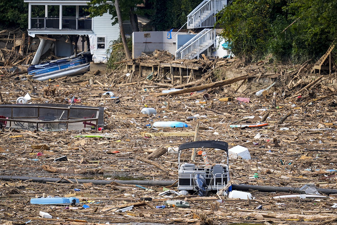 Debris is strewn on the lake in the aftermath of Hurricane Helene, Wednesday, Oct. 2, 2024, in Lake Lure, N.C. (AP Photo/Mike Stewart)