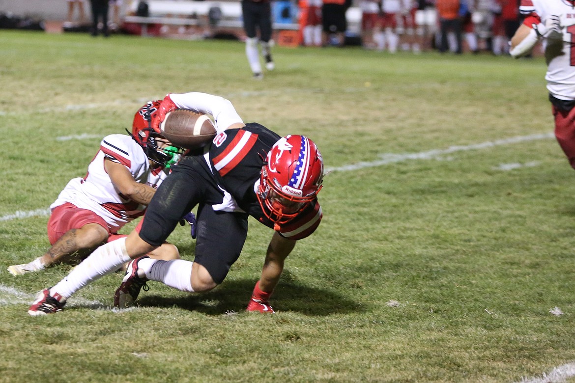 Othello junior RJay Garza (2) fights for extra yards on a 22-yard reception