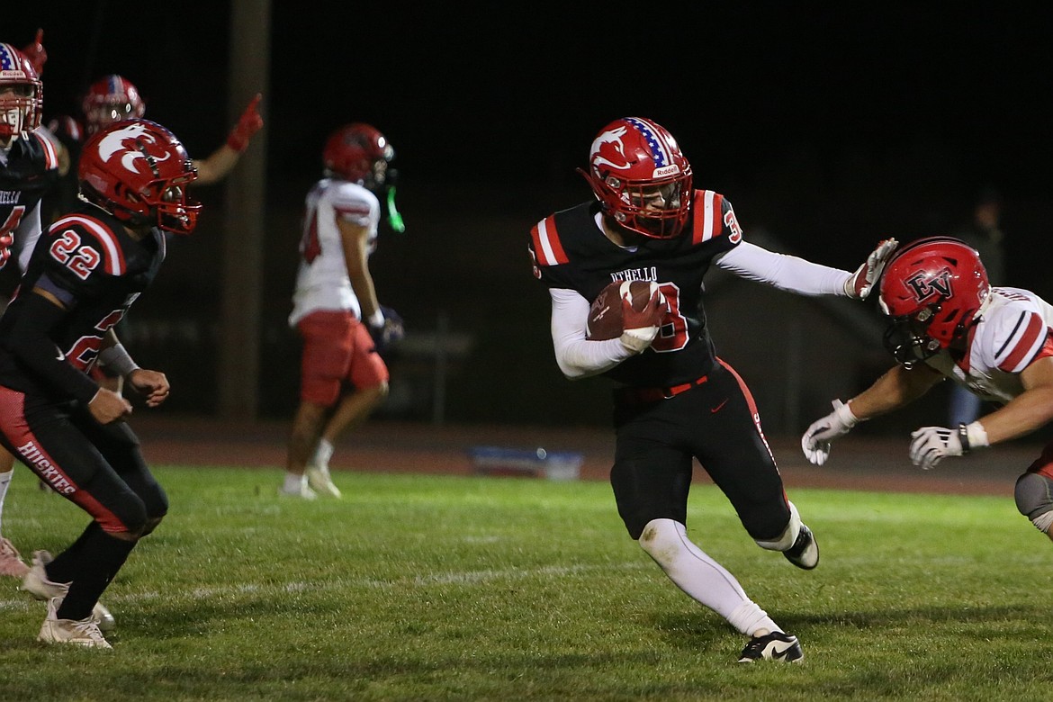 Othello junior Gavin Carl (38) returns an intercepted pass late in the fourth quarter against East Valley on Friday night.