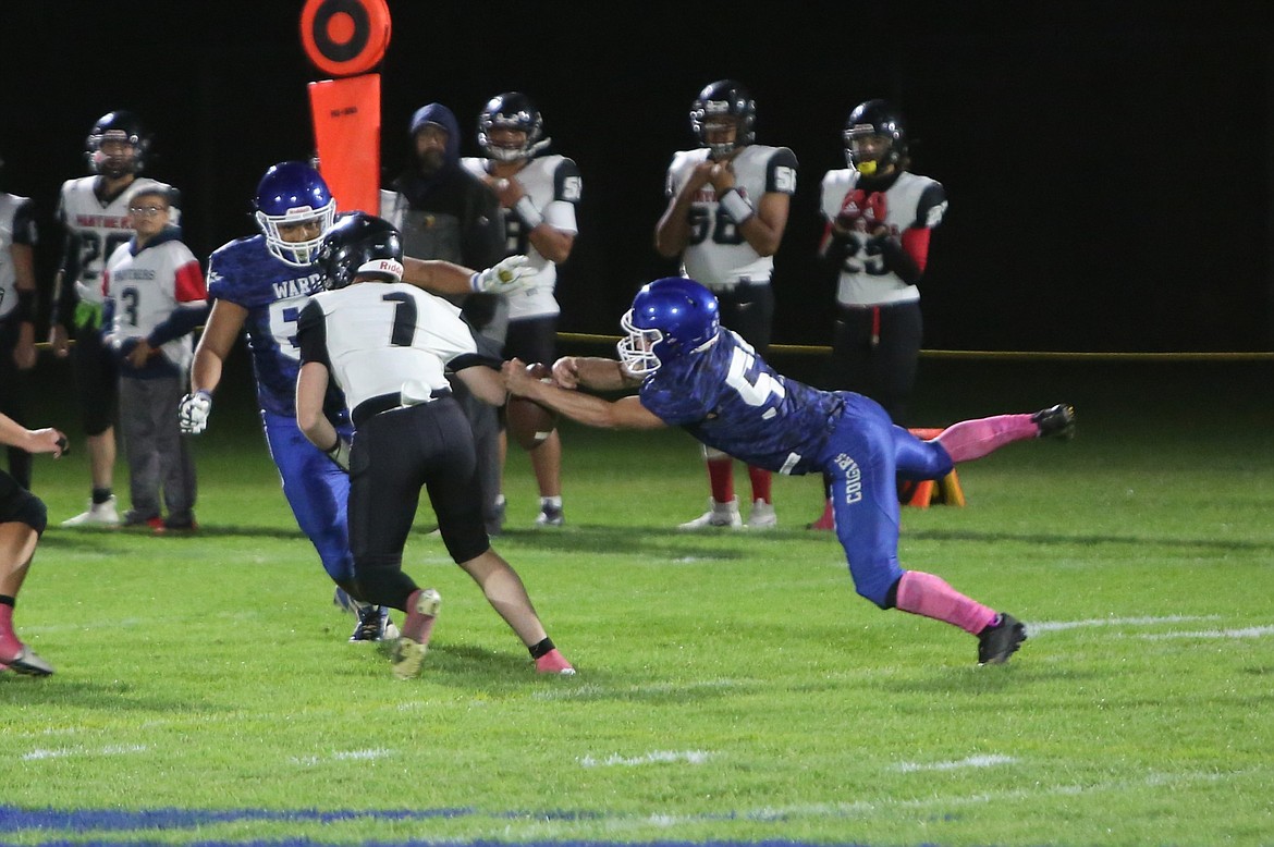 Warden senior TJ Visker, right, forces a fumble on River View’s first offensive drive of the game. The Cougars had seven sacks on Friday night, three of which came from Visker.