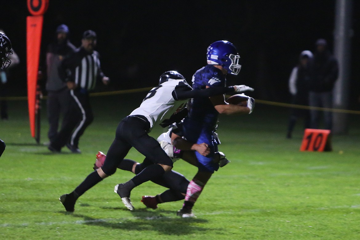 Warden junior Rhett Jorgensen, in blue, carries the ball into the end zone against Rivew View on Friday.