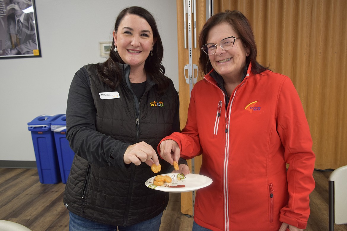 STCU Community Branch Manager Kerrie Petersen, left, and Senior Vice President at Banner Bank, Juliann Dodds eat freshly made breakfast rounds at the Simplot tour Oct. 4.