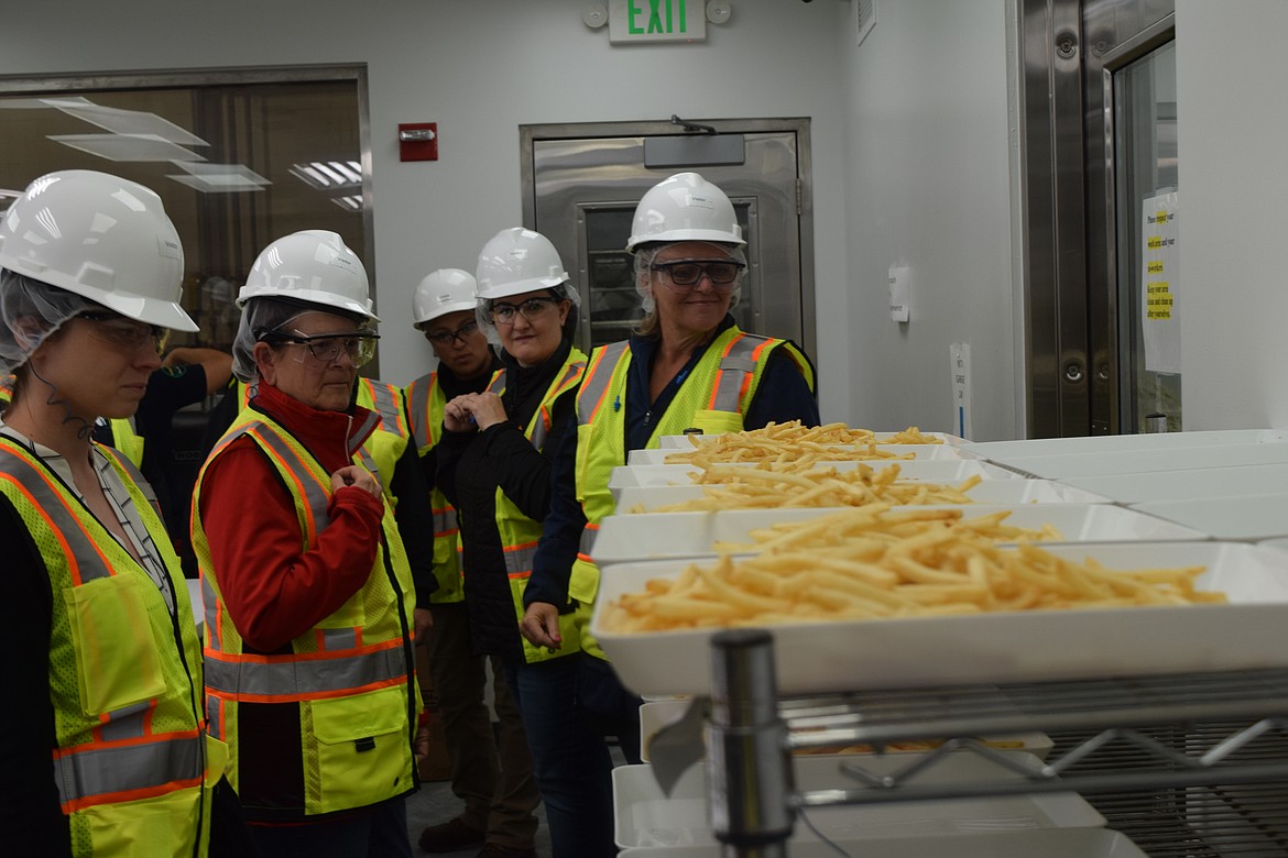 Members of the Association of Washington Business analyze the fry samples used for quality inspections during the tour Oct. 4.