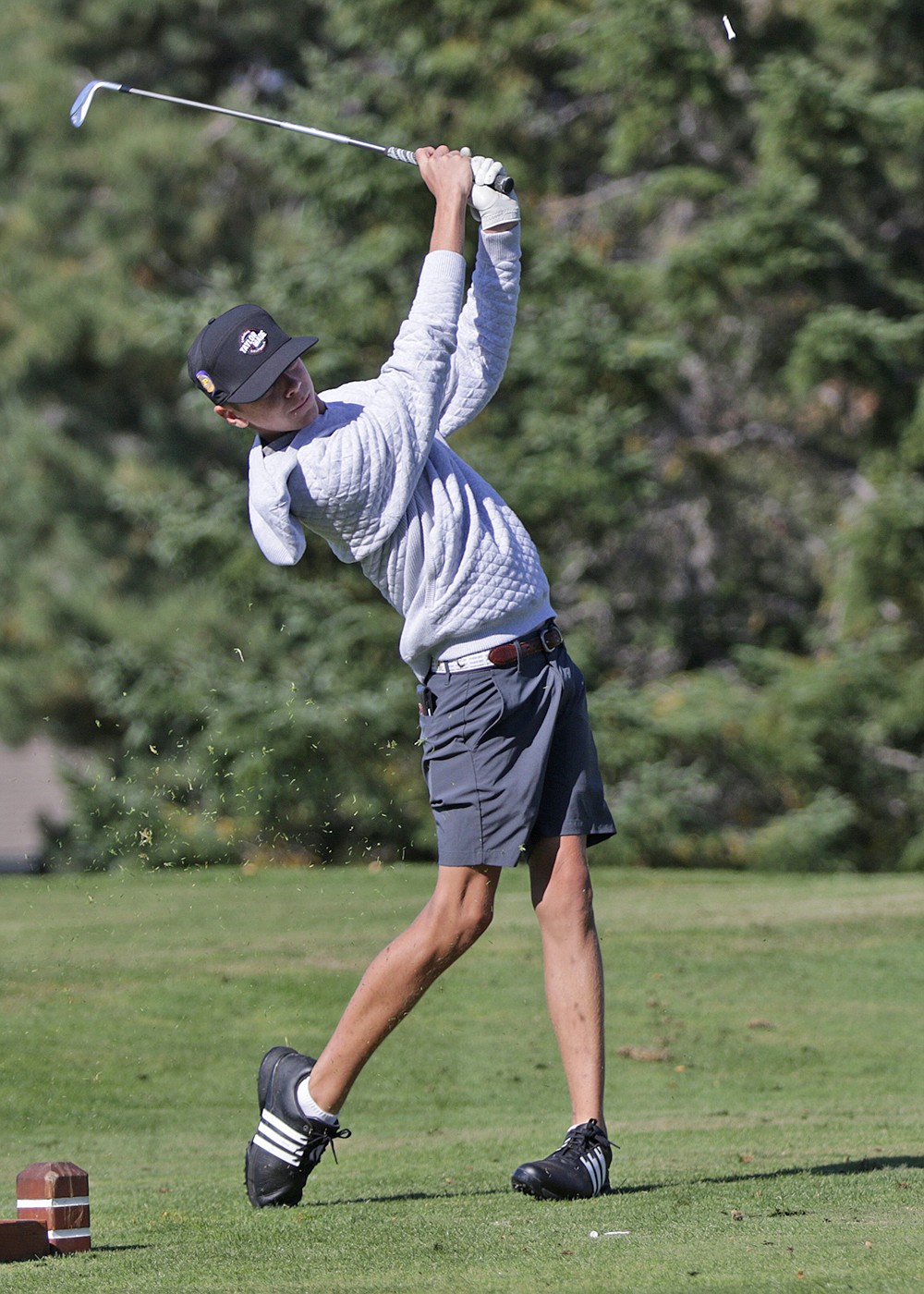 State Class A golf champ Max Milton tees off during last week's championship tourney at Polson Bay Golf Course. (Bob Gunderson photo)