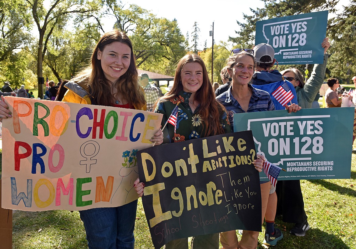 Whitefish high schoolers Lovey Gallagher and Tilly Daniels with family member Durae Belcer at the women's rights rally at Baker Park in Whitefish on Oct. 6. (Kelsey Evans/Whitefish Pilot)