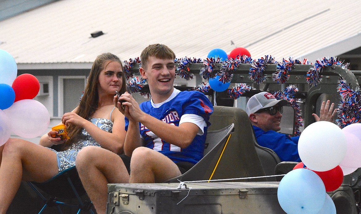 Sophomore candidates, Josie Crabb and Gannon Quinlan throw out candy as part of their royal duties. (Mineral Independent/Amy Quinlivan)