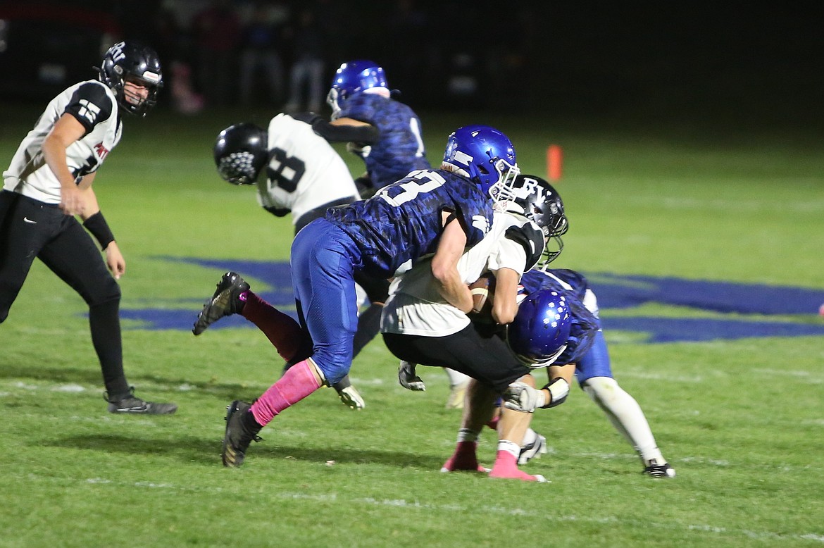 Warden defenders combine for a sack against River View Friday. The Cougars had seven sacks in a 28-6 win over the Panthers.