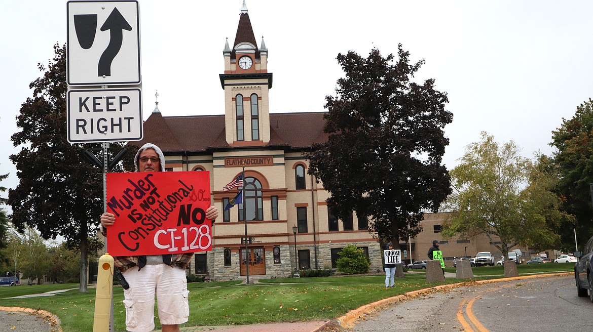 An attendee of an event held by Montana ProLife Coalition in Kalispell on Friday Oct. 4, 2024 holds a sign asking voters to vote "no" on constitutional initiative 128, which seeks to enshrine abortion access in Montana's constitution. (Taylor Inman/Daily Inter Lake)