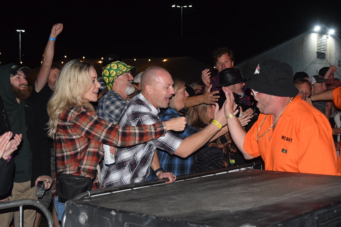 Members of Grand Royale, a Beastie Boys Tribute band, high-five crowd members after concluding their set.