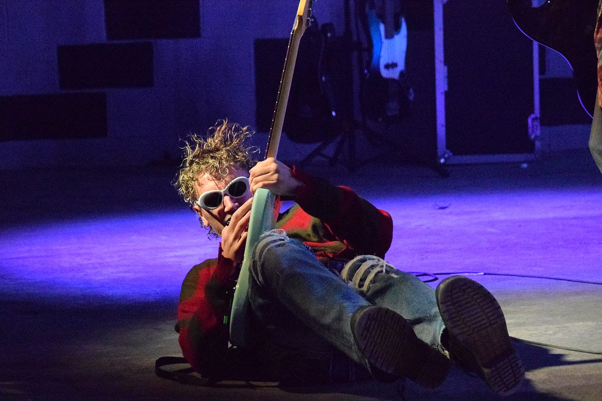 Nick Stone, singer and guitarist for Nevermind, a Nirvana tribute band, shreds his guitar on the floor of the stage during the opening song. During the closing song, the teal guitar was smashed.