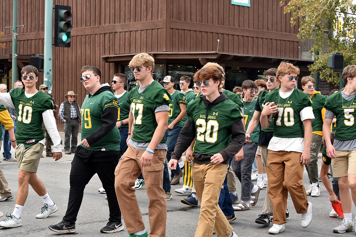 Football players walk the streets at the homecoming parade Friday, Oct. 4. (Kelsey Evans/Whitefish Pilot)