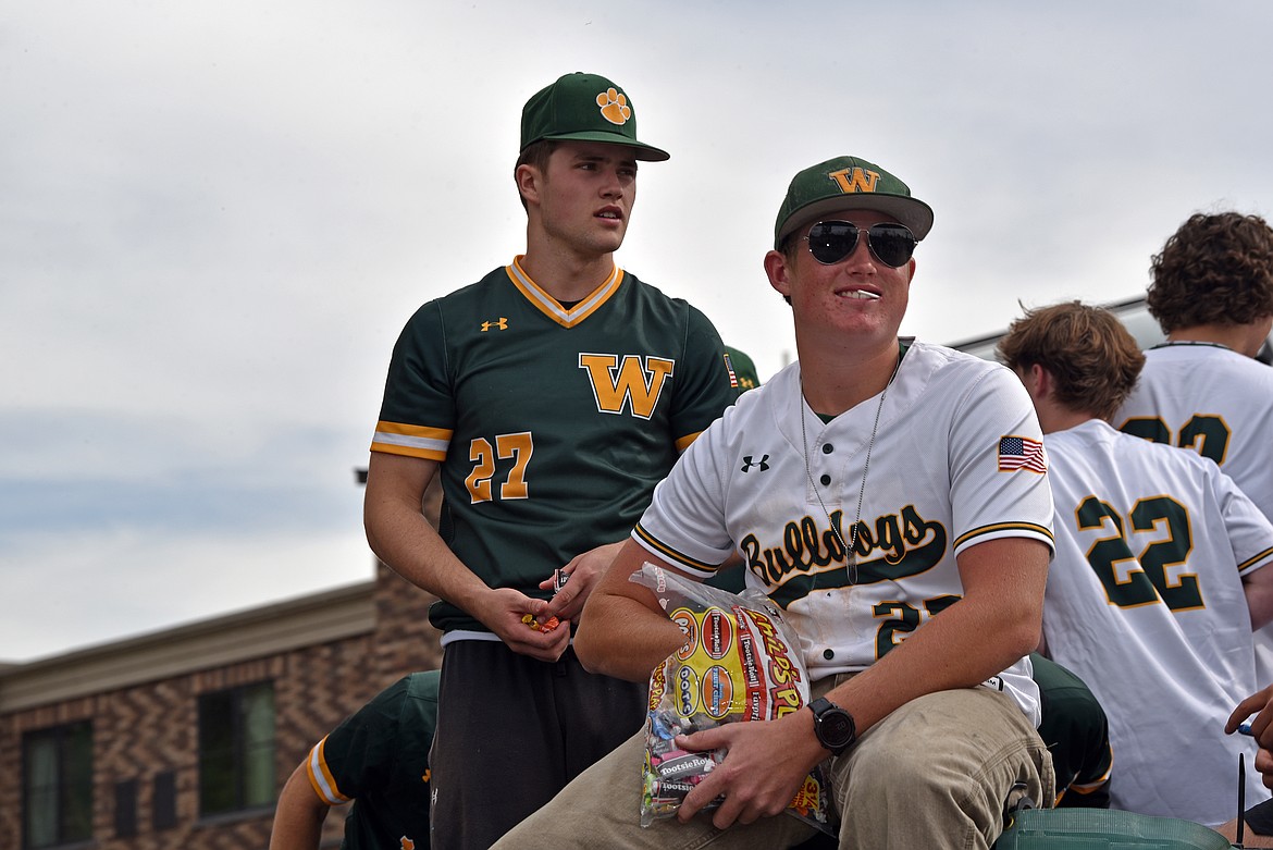 Baseball players toss out candy at the homecoming parade on Friday, Oct. 4. (Kelsey Evans/Whitefish Pilot)