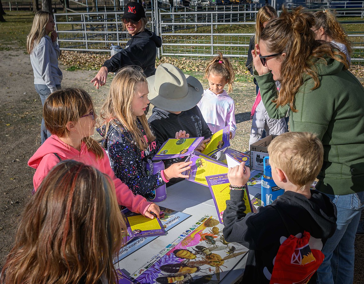 Eastern Sanders County Extension member Emily Baker and Green Mountain Conservation District member Morgan Owens show Noxon students the importance of pollinators in nature. (Tracy Scott/Valley Press)