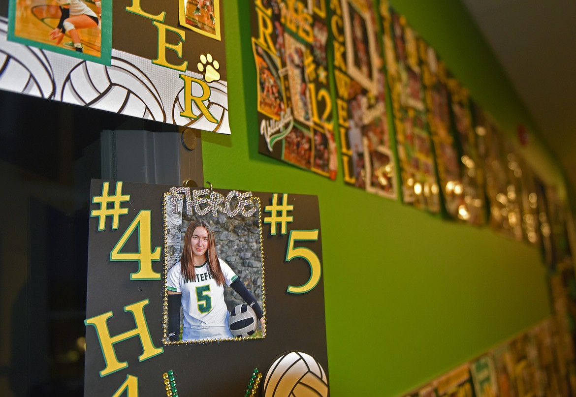 A section of a wall at Whitefish High School is covered with volleyball posters created by Price's scrapbooking business. (Kelsey Evans/Whitefish Pilot)