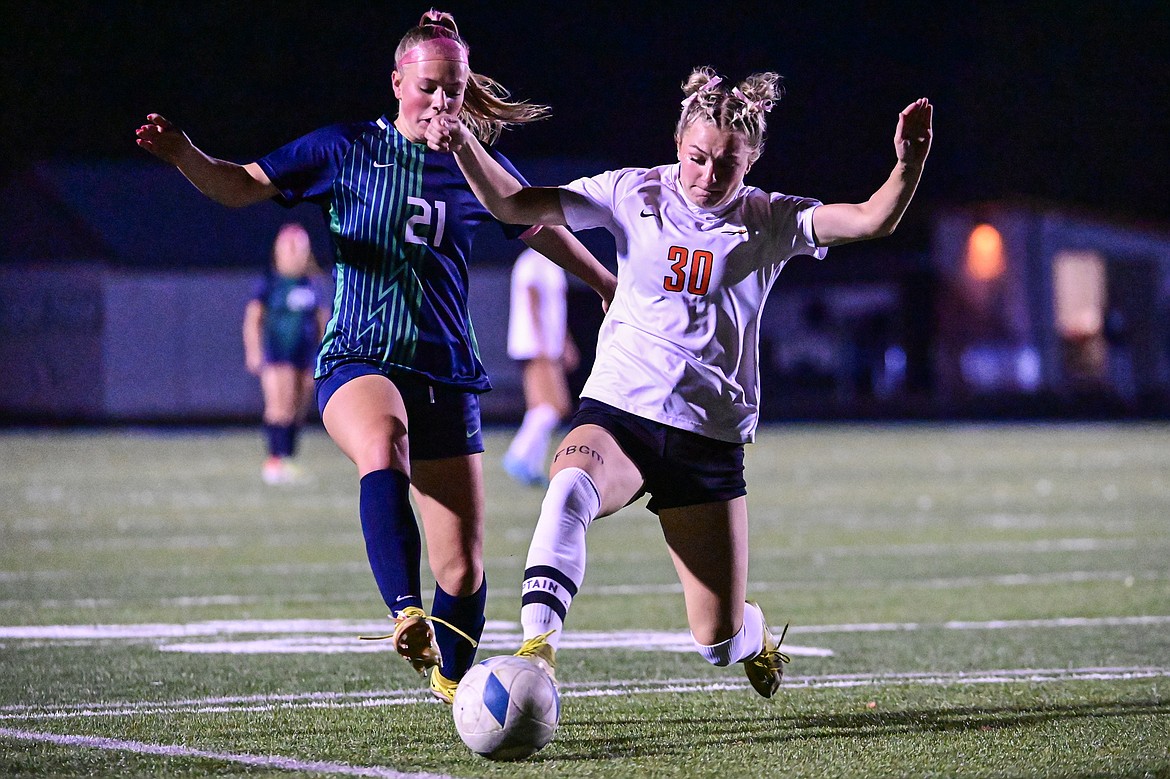 Glacier's Emmery Schmidt (21) battles Flathead's Alivia Rinehart (30) for possession in the first half against Flathead at Legends Stadium on Tuesday, Oct. 8. (Casey Kreider/Daily Inter Lake)