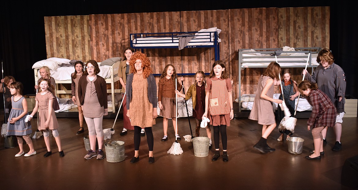 Eleven-year-old Annie (Carlee Howard), center, and the other orphans sing about their hard-knock life in the Masquers Theater production of “Annie,” which opens Oct. 18.