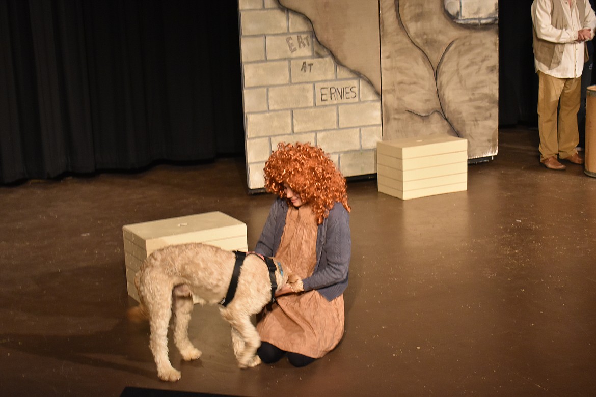 Runaway Annie (Carlee Howard) meets her new friend Sandy in the Masquers production of Annie, which opens Oct. 18. Director Clifford Bresee said he was a little uncertain at first about using a live animal in the play, but castmate Cassi Nelson’s dog Nova has taken to the role well.