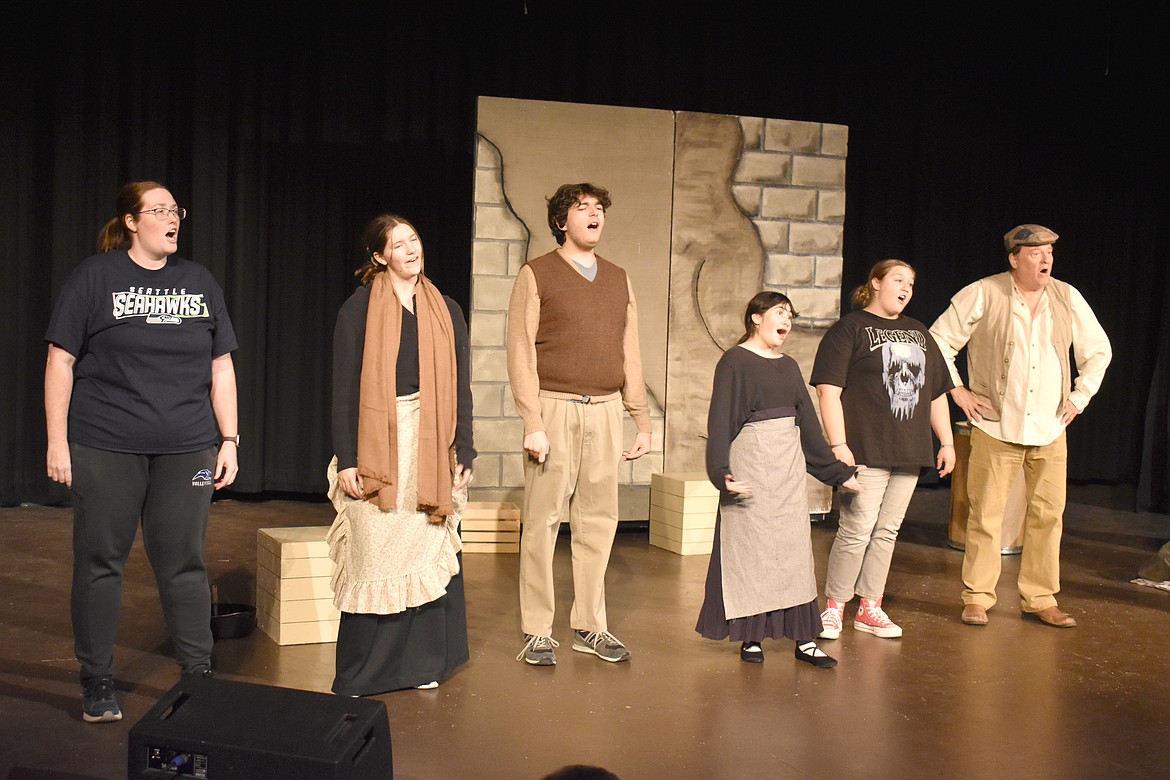 Residents of Hooverville, a homeless camp named for former President Herbert Hoover, sing scathingly about him at the Masquers Theater rehearsal of “Annie.”