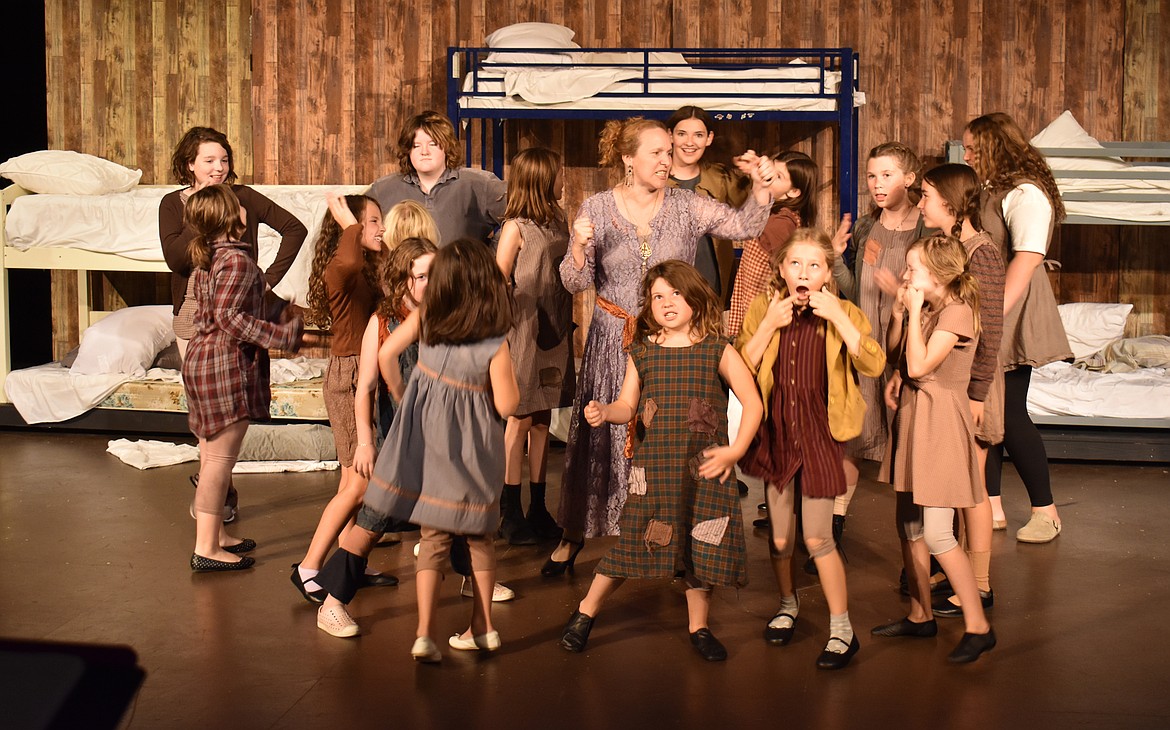 Orphanage keeper Miss Hannigan (Cassi Nelson) is dripping with little girls in the Masquers Theater production of “Annie,” opening Oct. 18.