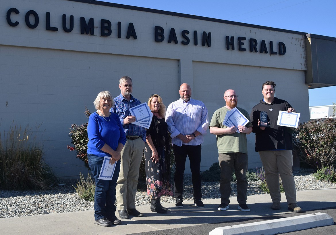 Columbia Basin Herald staff stand in the October sunshine for a quick photo to humor their proud editor, general manager/publisher and executive publisher.  Pictured from left to right are: Senior Reporter Cheryl Schweizer, Senior Reporter Joel Martin, Marketing & Audience Development Director Dana Moreno, General Manager/Publisher Bob Richardson, Managing Editor R. Hans Miller and Sports Reporter Ian Bivona.