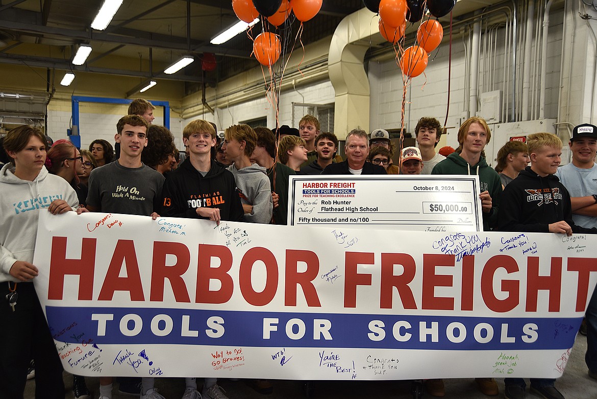 Flathead High School students surprise automotive teacher Rob Hunter, center, with a Harbor Freight Tools for Schools $50,000 prize on Tuesday, Oct. 8, 2024, in the auto shop. (Hilary Matheson/Daily Inter Lake)