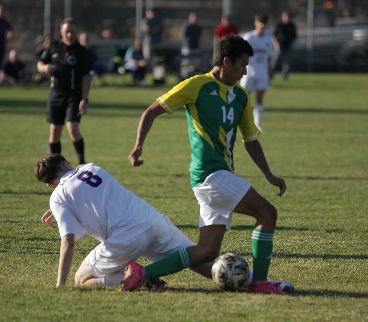 JASON ELLIOTT/Press
Lakeland junior defender Kyle Fritz plays the ball off the foot of Lewiston junior John Millard in the first half of a 5A Region 1 boys soccer match at Sunrise Rotary Field in Rathdrum.