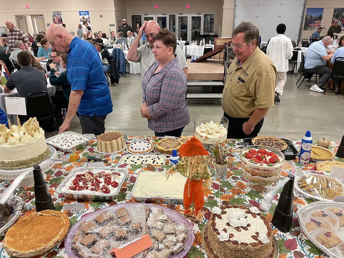 Attendees at a previous Youth Dynamics auction eye the goodies arrayed for the dessert dash. This year’s event will bring back the dessert auction Oct. 19.