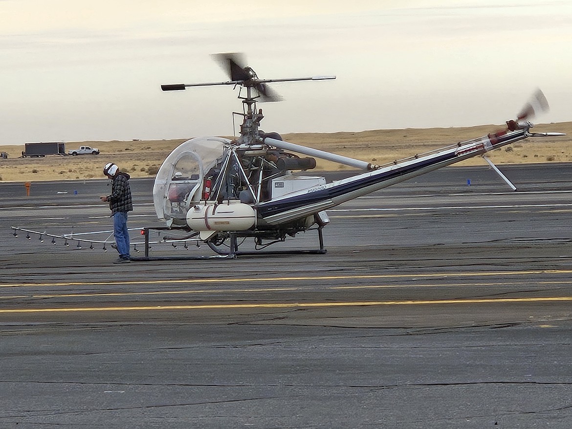 Airplanes aren't the only aircraft used in crop management. Drones or helicopters like the one shown here are used as well.