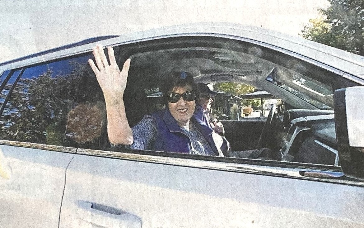 In 2019, Nancy Runge waves to the Coeur d’Alene Homecoming Parade crowd while her husband, John, drives.