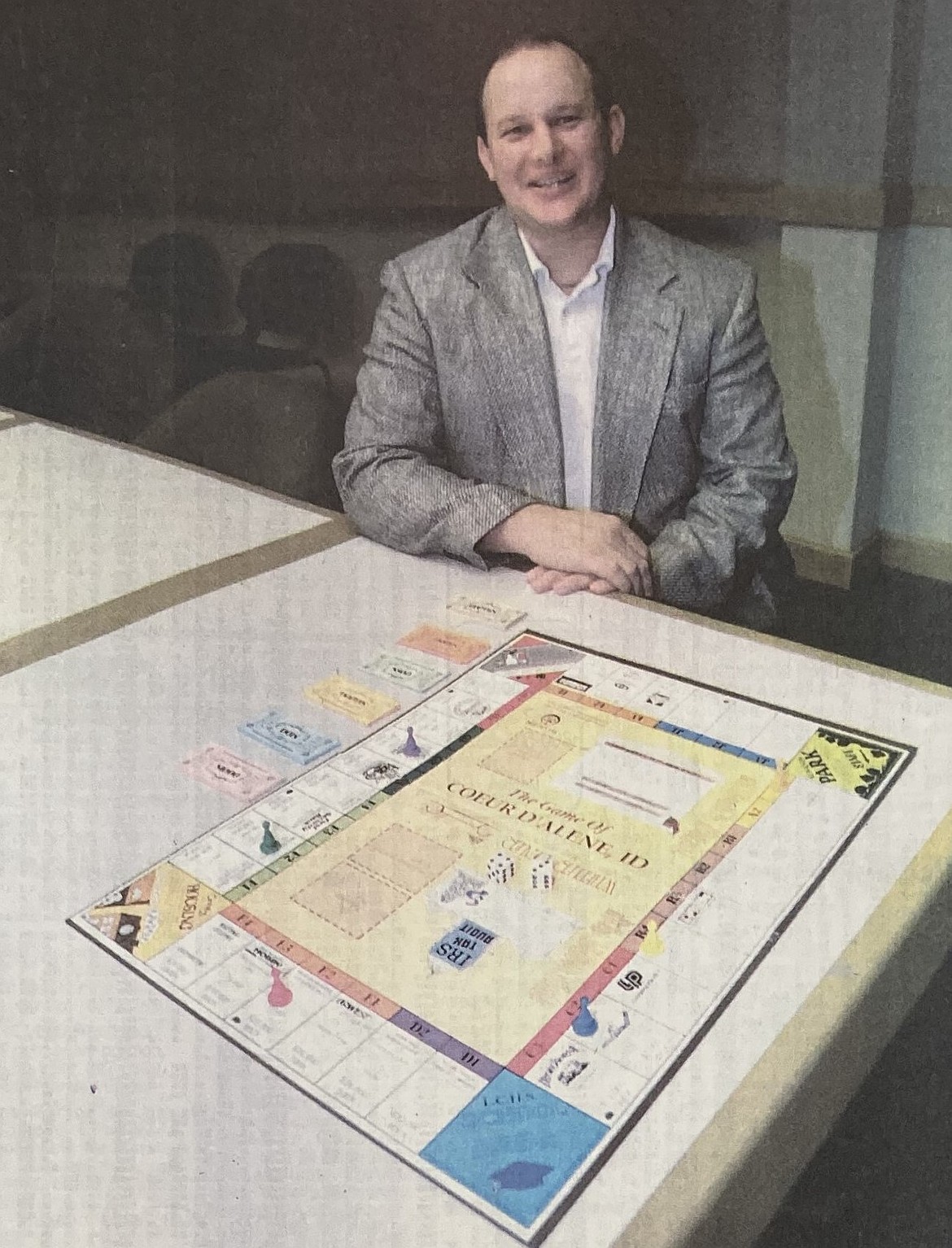 In 1994, Kelly Coon, vice president of the Coeur d’Alene Kiwanis Club, displays The Game of Coeur d’Alene.