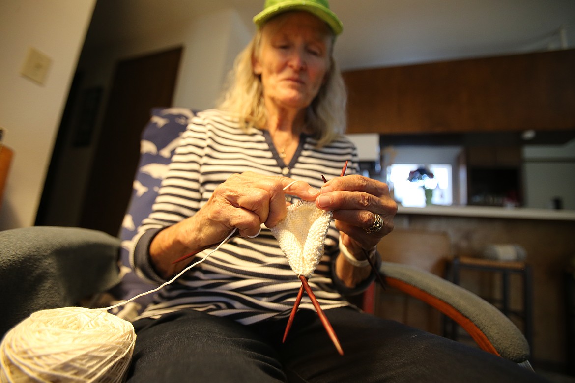 Bag and Boob Babes volunteer Elaine Kimball knits a Knitted Knocker at her home Tuesday.