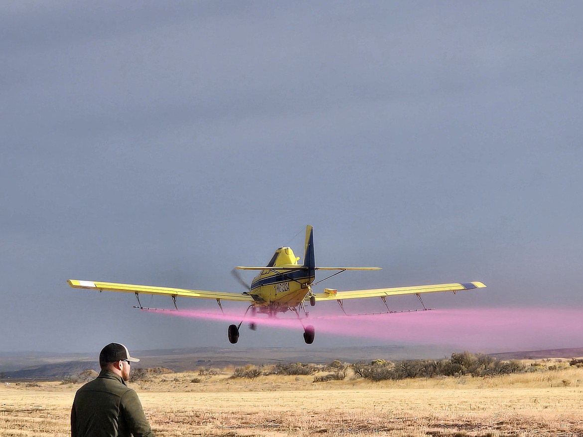 A crop duster sprays a test pattern during Friday's fly-in event at the Port of Ephrata.