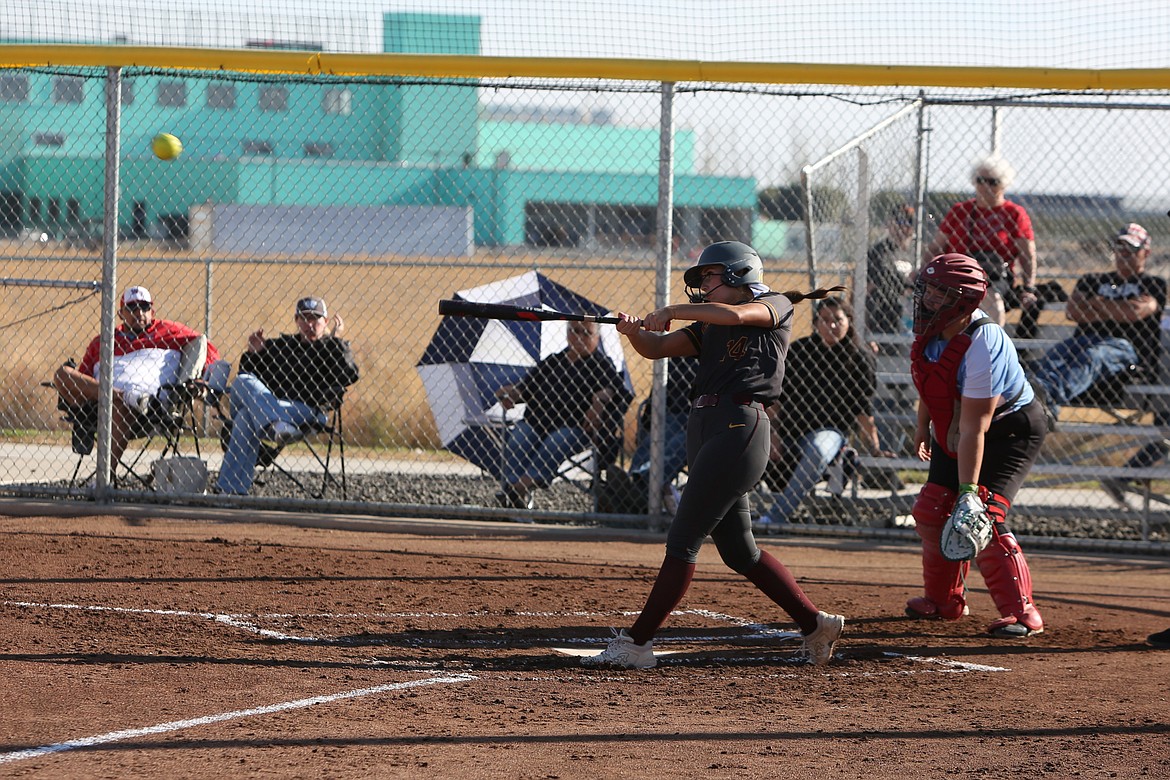 Moses Lake senior Paige Richardson (14) makes contact with a pitch during Tuesday’s doubleheader against West Valley (Yakima).