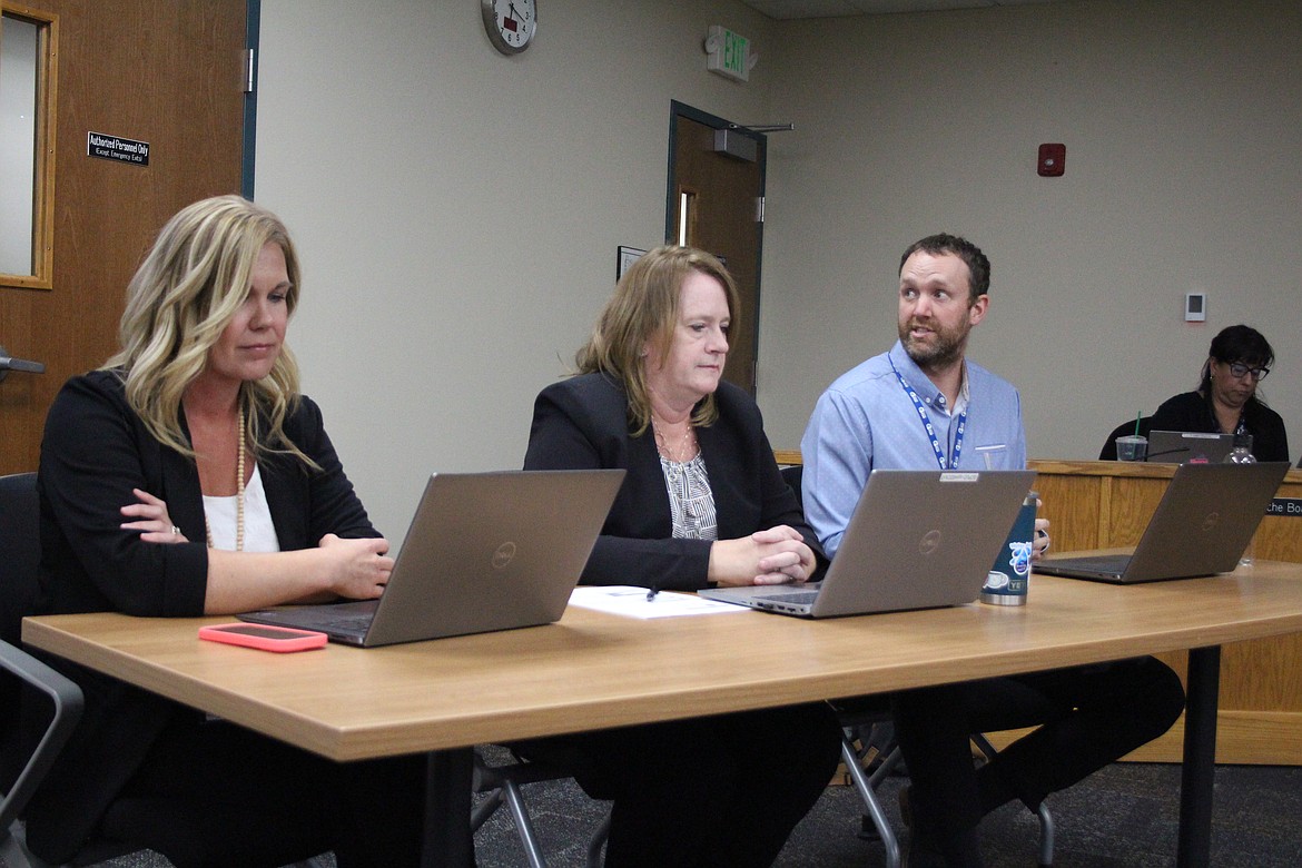 Bryndon Ecklund, right, lead financial analyst for the Grant County PUD, reviews the 2025 budget during a public hearing Tuesday. Terrah Bicondova, left, manager of budget and reporting, and Jennifer Sager, center, senior manager of accounting, follow along.