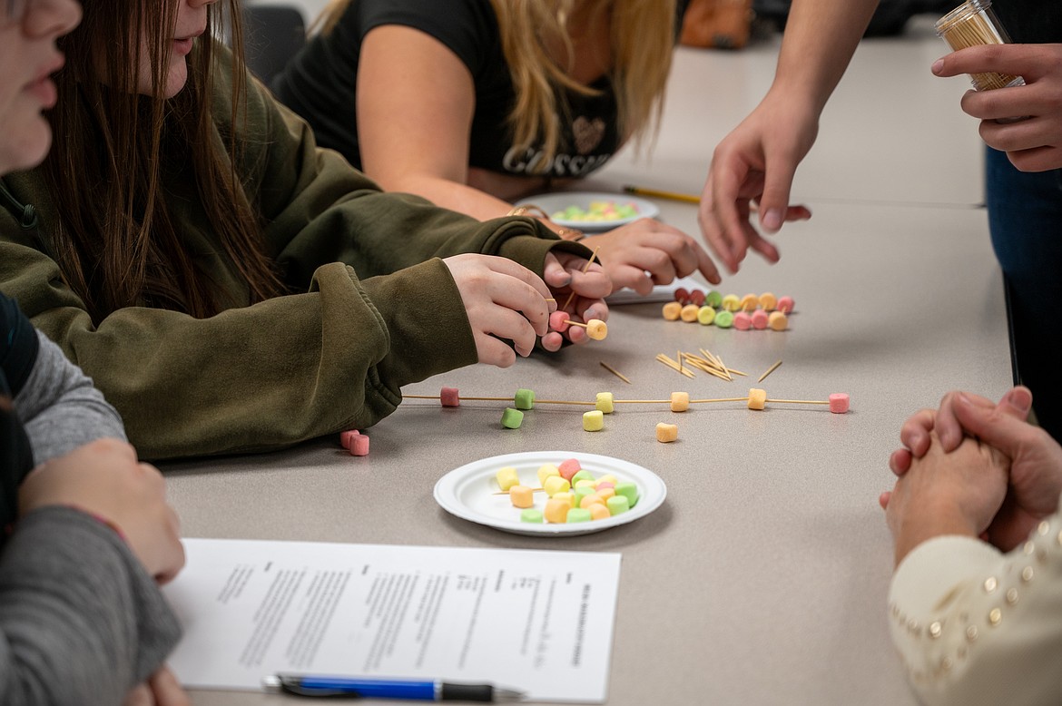 Young women from local high schools learned the basics of DNA through a building exercise during this week's Women in Science and Engineering event.