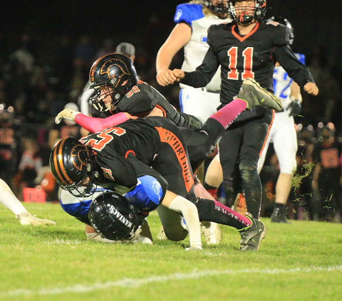 Priest River High junior Linden Rainwater (50) and sophomore Donovan Badlwin (53) tackle an Orofino running back during Friday night's matchup.