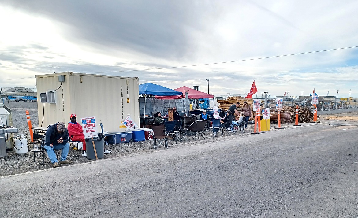 Boeing machinists maintain their picket line outside the company’s Moses Lake facility Friday. The company announced Friday that it would cut its workforce by 10% across the board.