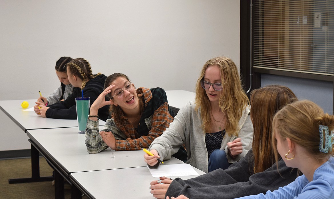 Young women from St. Maries High School talk out a robotics problem during the Women in Science and Engineering event.