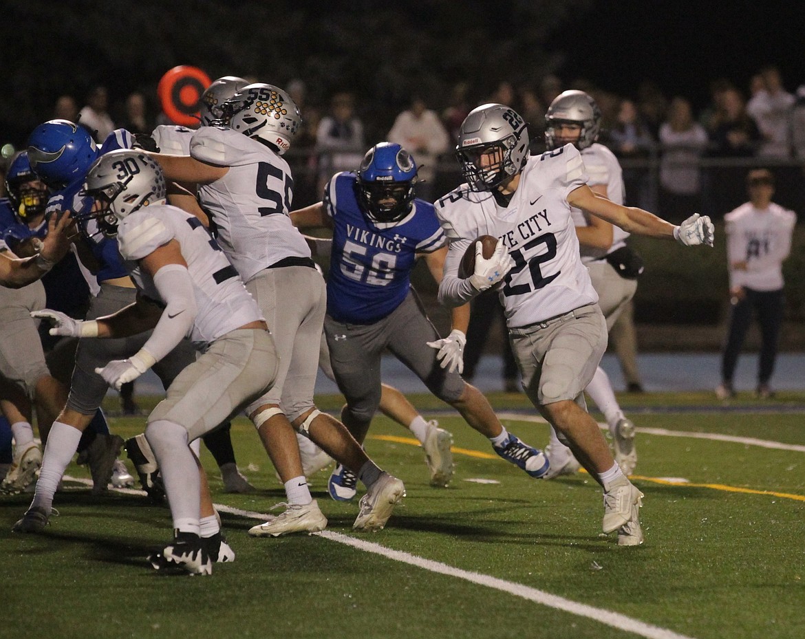 MARK NELKE/Press
Senior Gabe Wullenwaber of Lake City runs off-tackle against Coeur d'Alene on Friday night at Coeur d'Alene High.