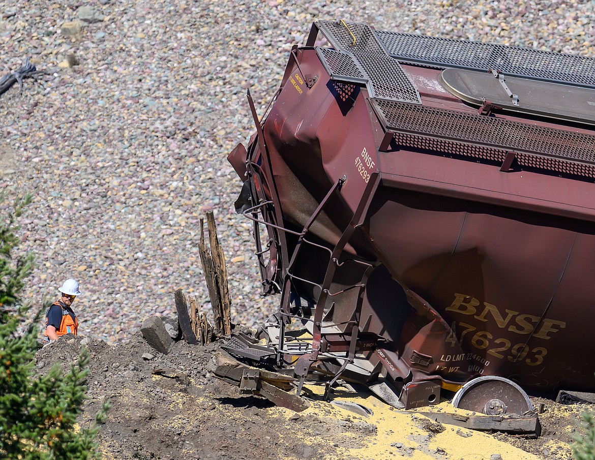 A worker looks over the wreckage.