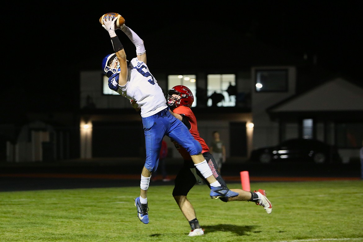 Warden senior Michael Gonzalez, in white, leaps up to haul in a 12-yard touchdown catch during the third quarter against Lind-Ritzville/Sprague Friday night. Gonzalez caught two touchdowns in the win.