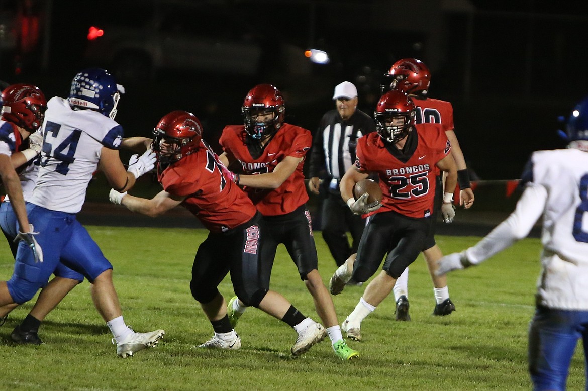 Lind-Ritzville/Sprague senior Brody Boness (25) follows blockers on a run play in the second quarter Friday night. Boness scored three touchdowns against Warden.