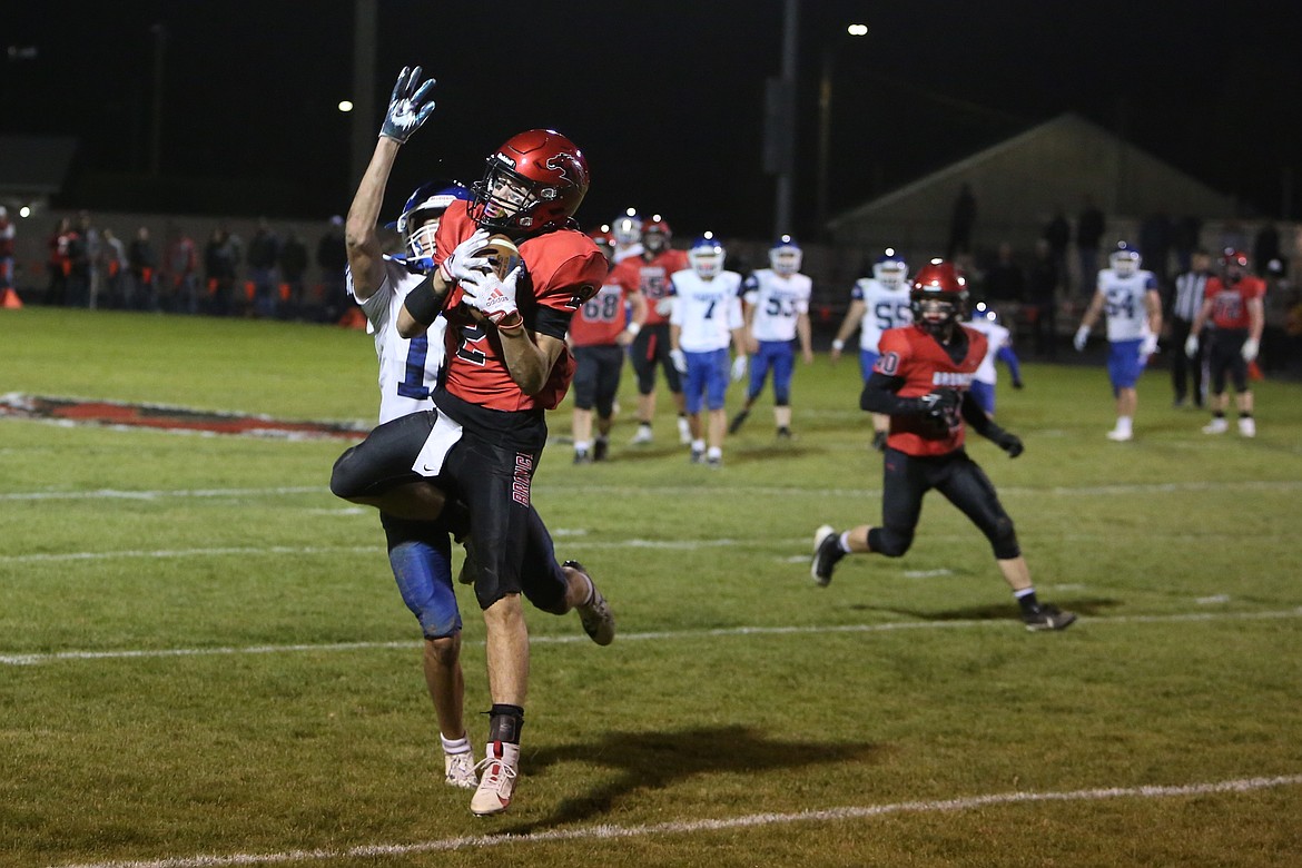 Lind-Ritzville/Sprague senior Zach Klein, in red, intercepts a pass in the second quarter against Warden on Friday.