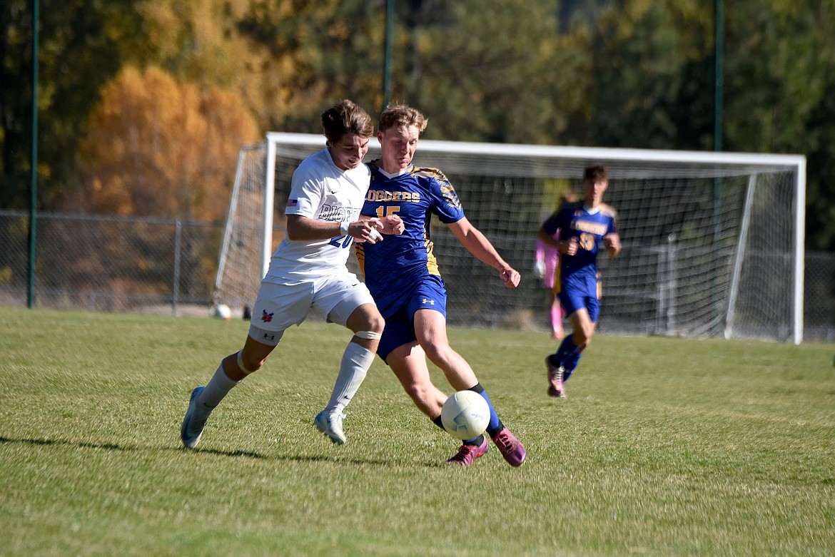 Libby junior Nolan Morris battles for control of the ball against Bigfork goal Saturday, Oct. 12, 2024. (Scott Shindledecker/The Western News)