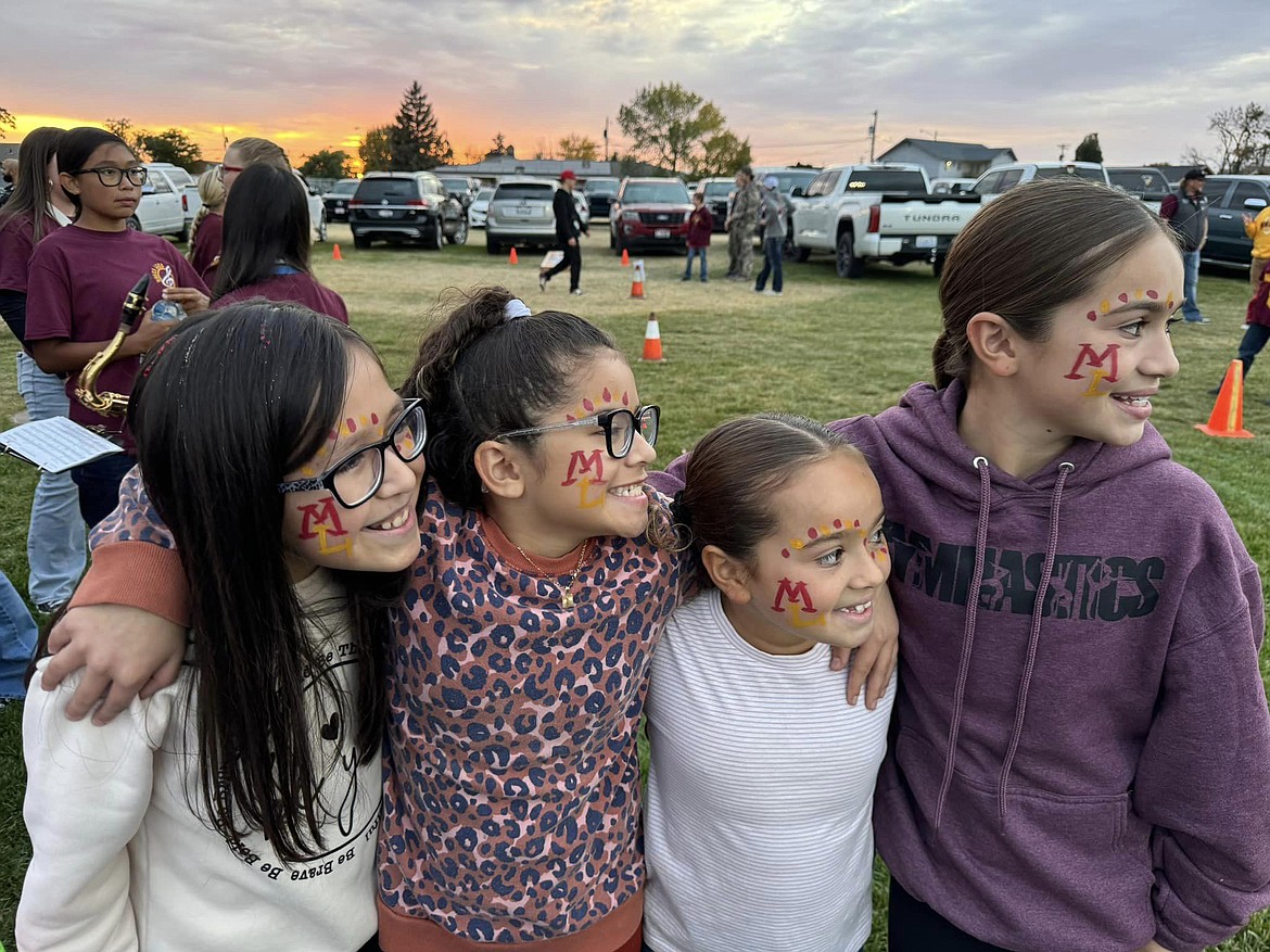 Four young attendees at Faith & Blue show their school spirit. The event was timed to take place right before a Moses Lake football game.